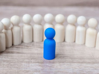 blue leader businessman with crowd of wooden men. leadership, bu