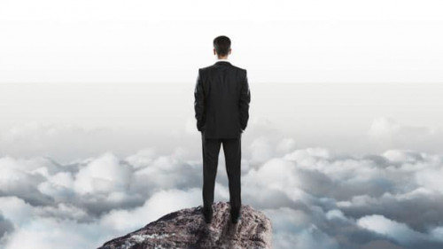 success concept with businessman onn top of rock