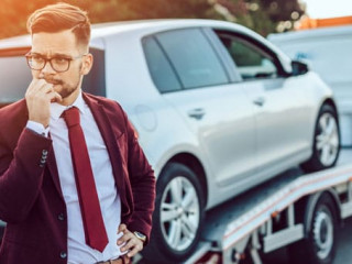 Elegant middle age business man using towing service for help ca