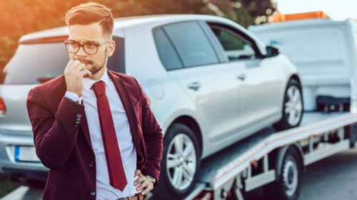 Elegant middle age business man using towing service for help ca