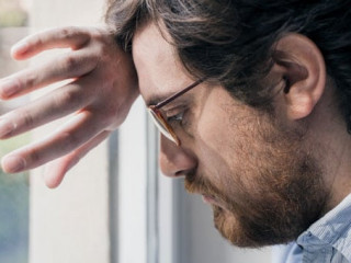 Portrait of one guy longing and looking through window