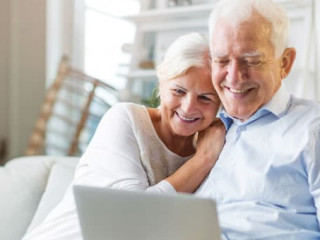 Senior couple using laptop computer at home
