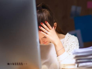 Young and beautiful businesswoman tired from work in the office