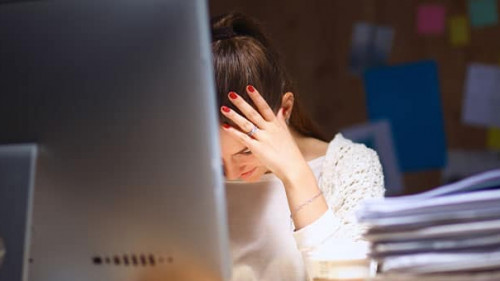 Young and beautiful businesswoman tired from work in the office