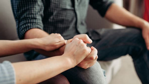 Couple hold hands, family psychology support