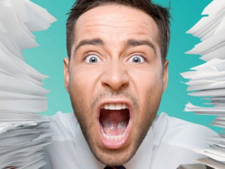 Business man with heap of papers