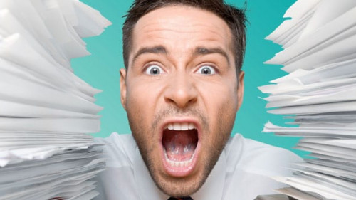 Business man with heap of papers