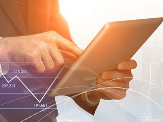 businessman with digital tablet and forex graphs