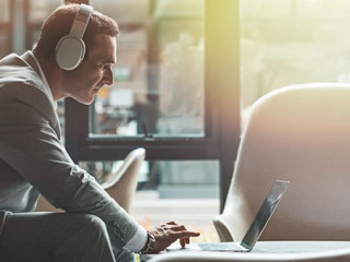 Continue what you've started. Businessman is using laptop in the office. Copy space on the right side