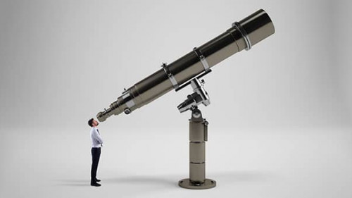 Little businessman looks in binoculars looking to the future concept.