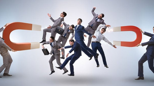 Businessman in recruitment concept with horseshoe magnet