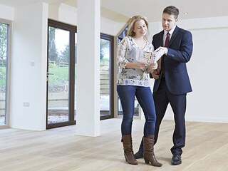 Estate Agent Showing Prospective Female Buyer Around Property