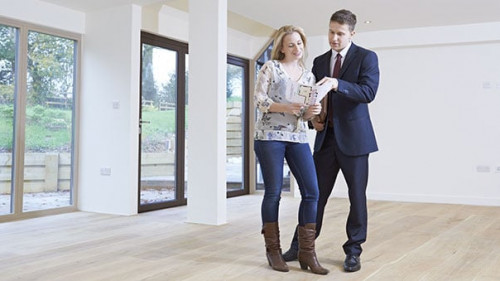 Estate Agent Showing Prospective Female Buyer Around Property