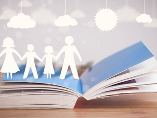Cardboard figures of the family on opened book