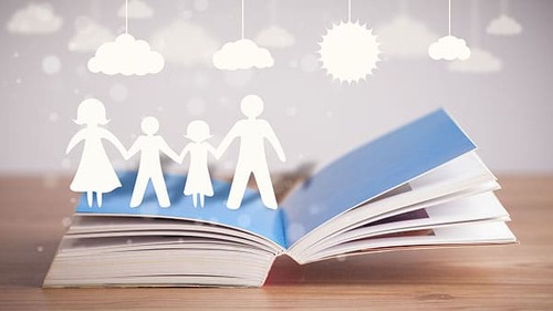 Cardboard figures of the family on opened book