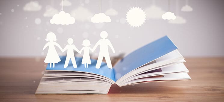 Cardboard figures of the family on opened book