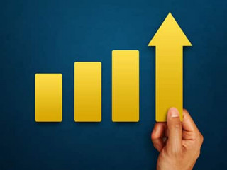 Businessman is touching arrows pointing up with graph as a symbo