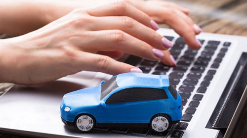 Small Blue Car On Laptop Keypad