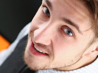 Young smile man at office workspace closeup