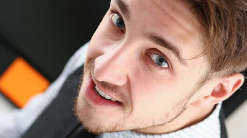 Young smile man at office workspace closeup