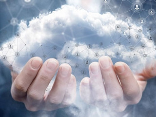 A businesswoman holding a cloud with network connections.