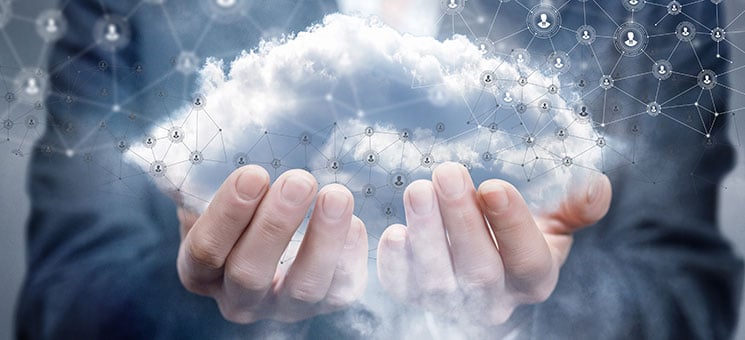 A businesswoman holding a cloud with network connections.