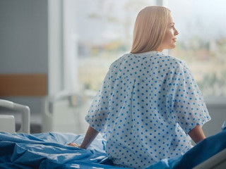Hospital Ward: Beautiful Caucasian Female Patient Sitting on a B