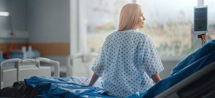 Hospital Ward: Beautiful Caucasian Female Patient Sitting on a B