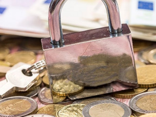 euro coin and banknote with lock. close up