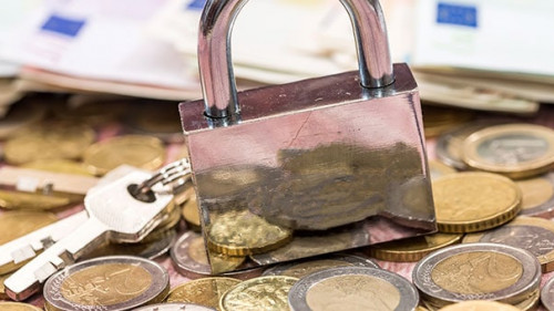 euro coin and banknote with lock. close up