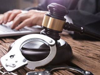 Close-up Of Handcuffs And Gavel In Courtroom