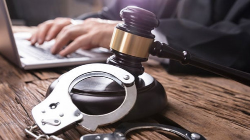 Close-up Of Handcuffs And Gavel In Courtroom