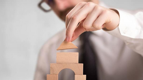 Businessman building a tower