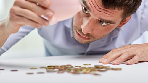 businessman with piggy bank and coins at office