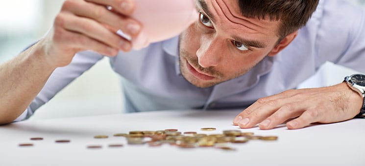 businessman with piggy bank and coins at office