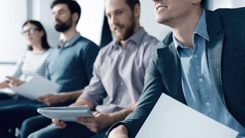 Pleasant man listening to the presentation with his colleagues