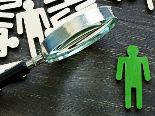 Human resource management and talent choice. Magnifying glass and figures of employees.