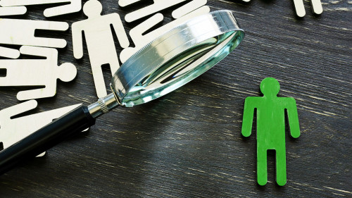 Human resource management and talent choice. Magnifying glass and figures of employees.