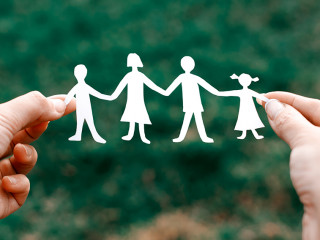 four little men in caring hands