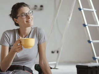 Woman doing a home renovation and having a coffee break