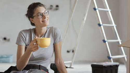 Woman doing a home renovation and having a coffee break
