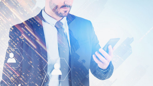 Man looking at phone in city, social media