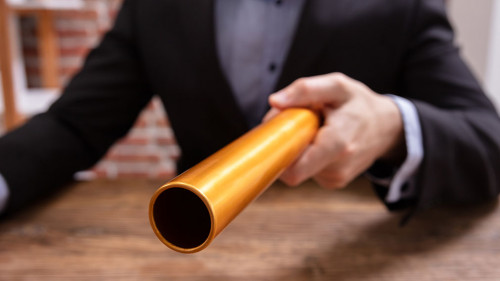 Person Holding Golden Relay Baton