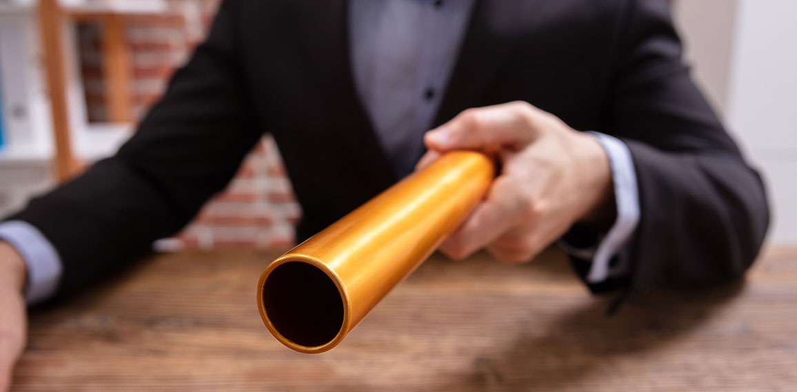 Person Holding Golden Relay Baton
