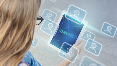 Blonde girl communicating online via tablet on city street. Collage with global community icons on virtual screen