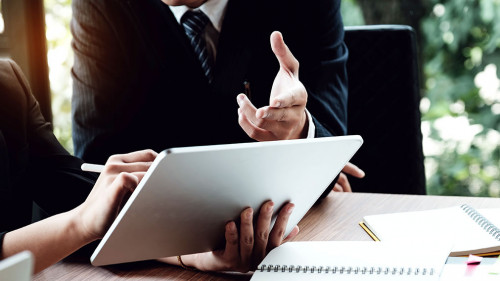 Business woman and lawyers discussing and using digital tablet