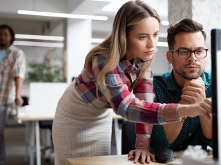 Group of business people and software developers working as a team in office