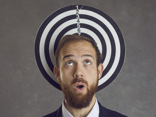 Unlucky businessman caught in a dangerous business trap becomes a dartboard target