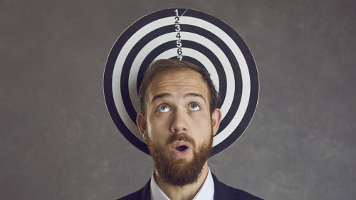 Unlucky businessman caught in a dangerous business trap becomes a dartboard target