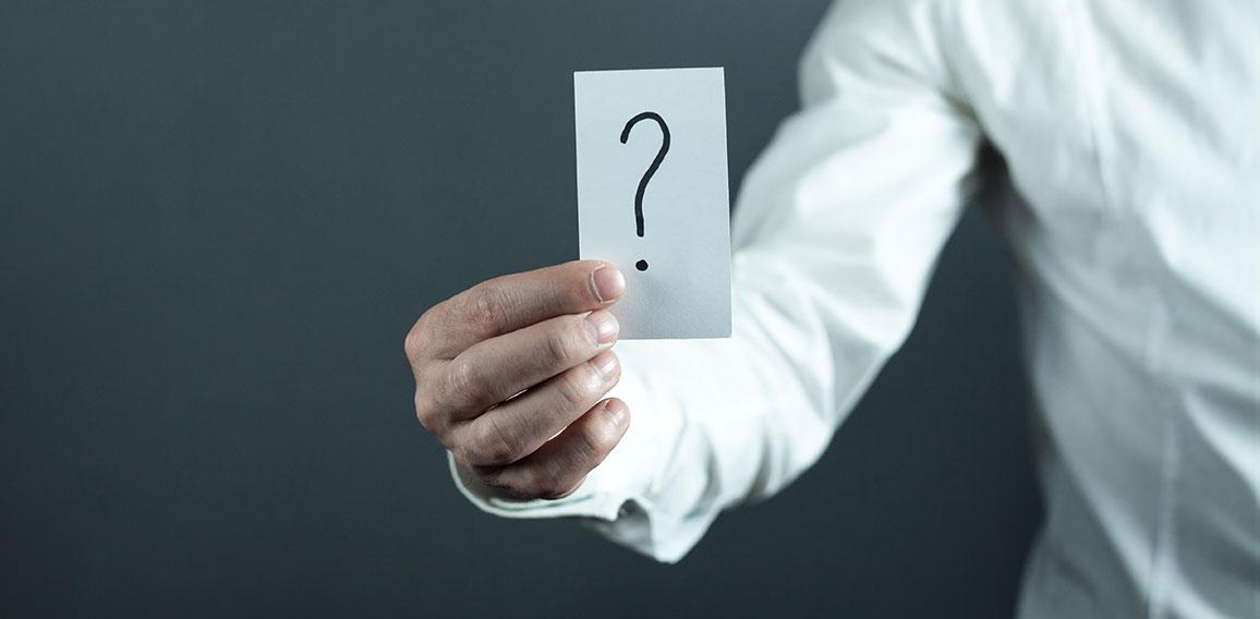 Man holding paper with question mark.